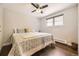 Bright bedroom featuring a ceiling fan, dark wood floors, and a comfortable bed next to a window at 5254 W Oberlin Dr, Denver, CO 80235