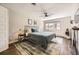 Bedroom with dark wood floors, rug, and large window with natural light coming in the room at 5254 W Oberlin Dr, Denver, CO 80235