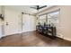 Bright dining area with sliding barn door, hardwood floors, and ample natural light at 5254 W Oberlin Dr, Denver, CO 80235