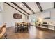The dining room features exposed beams, a wood table with seating for four, and French doors leading to the backyard at 5254 W Oberlin Dr, Denver, CO 80235