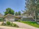 Attractive home exterior with well-manicured landscaping, a paved driveway, and green lawn at 5254 W Oberlin Dr, Denver, CO 80235
