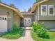 Inviting front entrance with beautiful landscaping and charming double doors at 5254 W Oberlin Dr, Denver, CO 80235