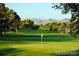 Scenic view of a manicured golf course with mature trees and distant mountain range at 5254 W Oberlin Dr, Denver, CO 80235