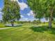 Picturesque golf course view featuring a tranquil pond and meticulously manicured greens at 5254 W Oberlin Dr, Denver, CO 80235