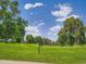 Scenic view of a meticulously maintained golf course showcasing lush green fairways and mature trees at 5254 W Oberlin Dr, Denver, CO 80235