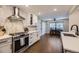Bright kitchen features stainless steel appliances, white cabinets, and a stylish backsplash at 5254 W Oberlin Dr, Denver, CO 80235