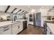 Spacious kitchen with stainless steel appliances, white cabinets, and island with hardwood floors at 5254 W Oberlin Dr, Denver, CO 80235
