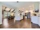 Open concept kitchen with stainless steel appliances, white cabinets, and hardwood floors at 5254 W Oberlin Dr, Denver, CO 80235