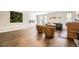 Bright living room featuring hardwood floors, comfortable seating, and a fireplace at 5254 W Oberlin Dr, Denver, CO 80235