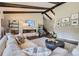 Bright living room boasts exposed beams, a modern fireplace, and expansive windows showcasing the outdoor scenery at 5254 W Oberlin Dr, Denver, CO 80235