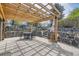 Stone patio features a wooden pergola, outdoor dining area, and multi-tiered stone garden at 5254 W Oberlin Dr, Denver, CO 80235