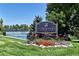 The Pinehurst Country Club sign with beautiful landscaping is featured on a bright day at 5254 W Oberlin Dr, Denver, CO 80235