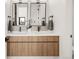 Modern bathroom featuring double vanity with wood cabinets, sleek fixtures and modern lighting at 4721 Elm Ct, Denver, CO 80211