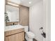 Chic powder room with custom vanity, modern fixtures, and a stylish tile accent wall at 4721 Elm Ct, Denver, CO 80211