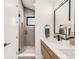 Modern bathroom features a double sink vanity, sleek fixtures, and a frameless glass shower at 4721 Elm Ct, Denver, CO 80211