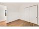Bright bedroom with hardwood floors, closet with sliding doors and open door at 4721 Elm Ct, Denver, CO 80211