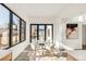 Bright breakfast nook features a glass table, modern chairs, and large windows at 4721 Elm Ct, Denver, CO 80211