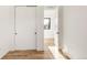 Bright hallway with hardwood floors, closet with sliding doors and natural light at 4721 Elm Ct, Denver, CO 80211