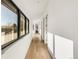Bright hallway featuring hardwood floors and large windows offering views of the outdoors at 4721 Elm Ct, Denver, CO 80211