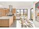 Stylish kitchen features a breakfast nook, stainless steel appliances, and white countertops at 4721 Elm Ct, Denver, CO 80211