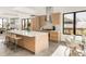 Open kitchen design includes an island with seating, stainless hood, and custom wood cabinets at 4721 Elm Ct, Denver, CO 80211