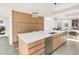 Modern kitchen with stainless steel appliances, large island, and custom wood cabinets at 4721 Elm Ct, Denver, CO 80211