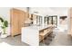 Bright and modern kitchen featuring a large island, stainless steel appliances, and sleek cabinetry at 4721 Elm Ct, Denver, CO 80211