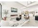 Open-concept living room featuring a linear fireplace, modern furnishings, and lots of natural light at 4721 Elm Ct, Denver, CO 80211