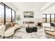 Bright living room featuring a linear fireplace, modern furniture, and large windows at 4721 Elm Ct, Denver, CO 80211