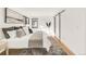 Bright main bedroom with modern decor, natural light, and a sliding barn door at 4721 Elm Ct, Denver, CO 80211