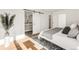 Comfortable main bedroom showcasing a sliding barn door that leads to the ensuite bathroom at 4721 Elm Ct, Denver, CO 80211