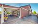 Exterior view of the back of the house, featuring a covered patio and a well-maintained yard at 18009 E 47Th Pl, Denver, CO 80249