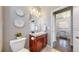 Half bath with tile floors, vanity, and decorative wall decor at 18009 E 47Th Pl, Denver, CO 80249