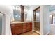 Bathroom with double vanity, tiled floors, and a glass enclosed shower at 18009 E 47Th Pl, Denver, CO 80249