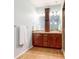 Bathroom with double vanity, tiled floors, and a glass enclosed shower at 18009 E 47Th Pl, Denver, CO 80249