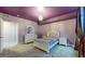 A bedroom with purple walls, carpet, white furniture, crystal chandelier, and dark curtains at 18009 E 47Th Pl, Denver, CO 80249