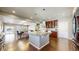 Spacious open kitchen with island, granite countertops, hardwood floors, and stainless appliances at 18009 E 47Th Pl, Denver, CO 80249