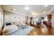 Open-concept living room flowing into the dining area with hardwood floors and recessed lighting at 18009 E 47Th Pl, Denver, CO 80249
