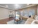 Bright and inviting living room with large windows, sleek hardwood floors, and a cozy seating area at 18009 E 47Th Pl, Denver, CO 80249