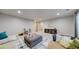 Living room with carpeted floor, cabinet with open shelving, and comfortable seating at 18009 E 47Th Pl, Denver, CO 80249
