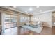 Relaxing living room with sliding door, hardwood floors, modern lighting, and a plush sectional sofa at 18009 E 47Th Pl, Denver, CO 80249