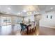 Open-concept living space with hardwood floors and modern lighting, perfect for entertaining and everyday living at 18009 E 47Th Pl, Denver, CO 80249