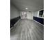 Spacious finished basement area features modern flooring, neutral paint and glass doors to the backyard at 3345 W Evans Ave, Denver, CO 80219