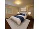 Serene bedroom featuring a comfortable bed, matching nightstands, and soft lighting for restful nights at 3345 W Evans Ave, Denver, CO 80219