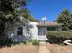 Charming single-story home featuring a cozy front porch and mature trees, offering great curb appeal at 3345 W Evans Ave, Denver, CO 80219