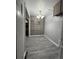 Spacious hallway with ample cabinet space and neutral gray walls, providing easy access throughout the home at 3345 W Evans Ave, Denver, CO 80219