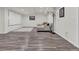 Finished basement featuring gray plank flooring, home theater screen, and comfortable sectional seating at 8248 S Yantley Ct, Aurora, CO 80016