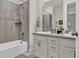 Bathroom featuring a shower over tub, double sinks, and stylish fixtures at 8248 S Yantley Ct, Aurora, CO 80016