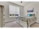 Bright bedroom features a bed with storage drawers and a large window at 8248 S Yantley Ct, Aurora, CO 80016