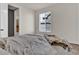 Simple bedroom with a neutral color palette, large window, and en-suite bathroom at 8248 S Yantley Ct, Aurora, CO 80016